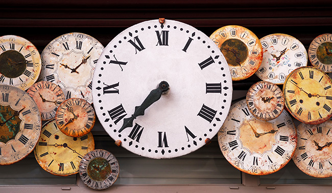 Several antique clock faces of different sizes and styles