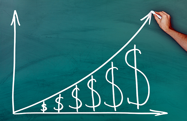 Hand holding chalk dollar growth chart on green blackboard