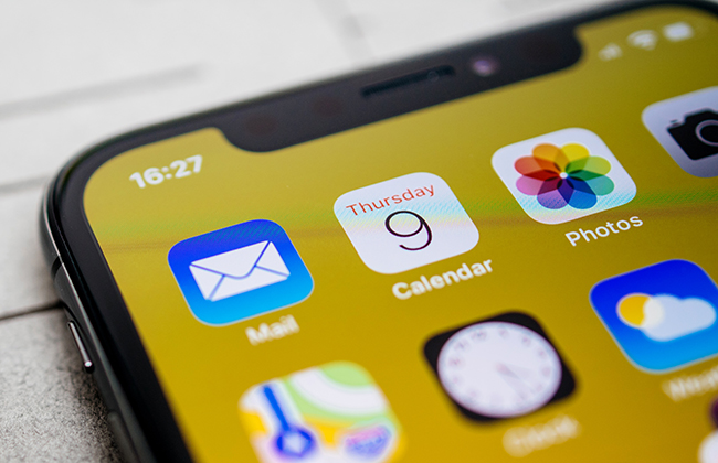 Paris, France - Nov 11, 2017: Apps icons details Latest Apple Computers iPhone 11 Pro featuring macro shot of the Calendar, Photos and Mail applications