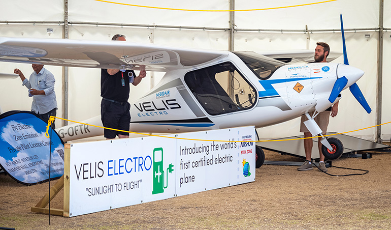 People look at a Pipistrel Velis Electro plane at Eastbourne Airshow 2022 in East Sussex, UK.The Velis Electro is the world's first certified electric plane.